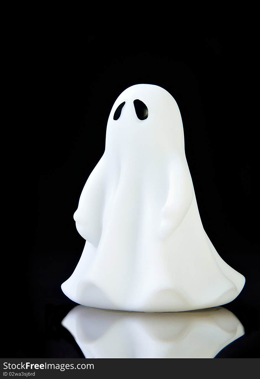 The perfect ghost on black background with reflection and copy space