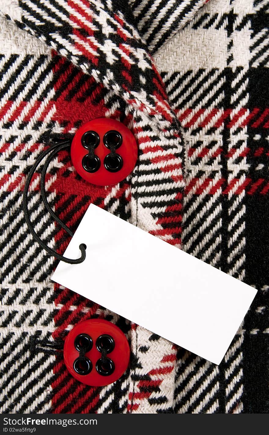 Blank price tag on checked coat with red buttons