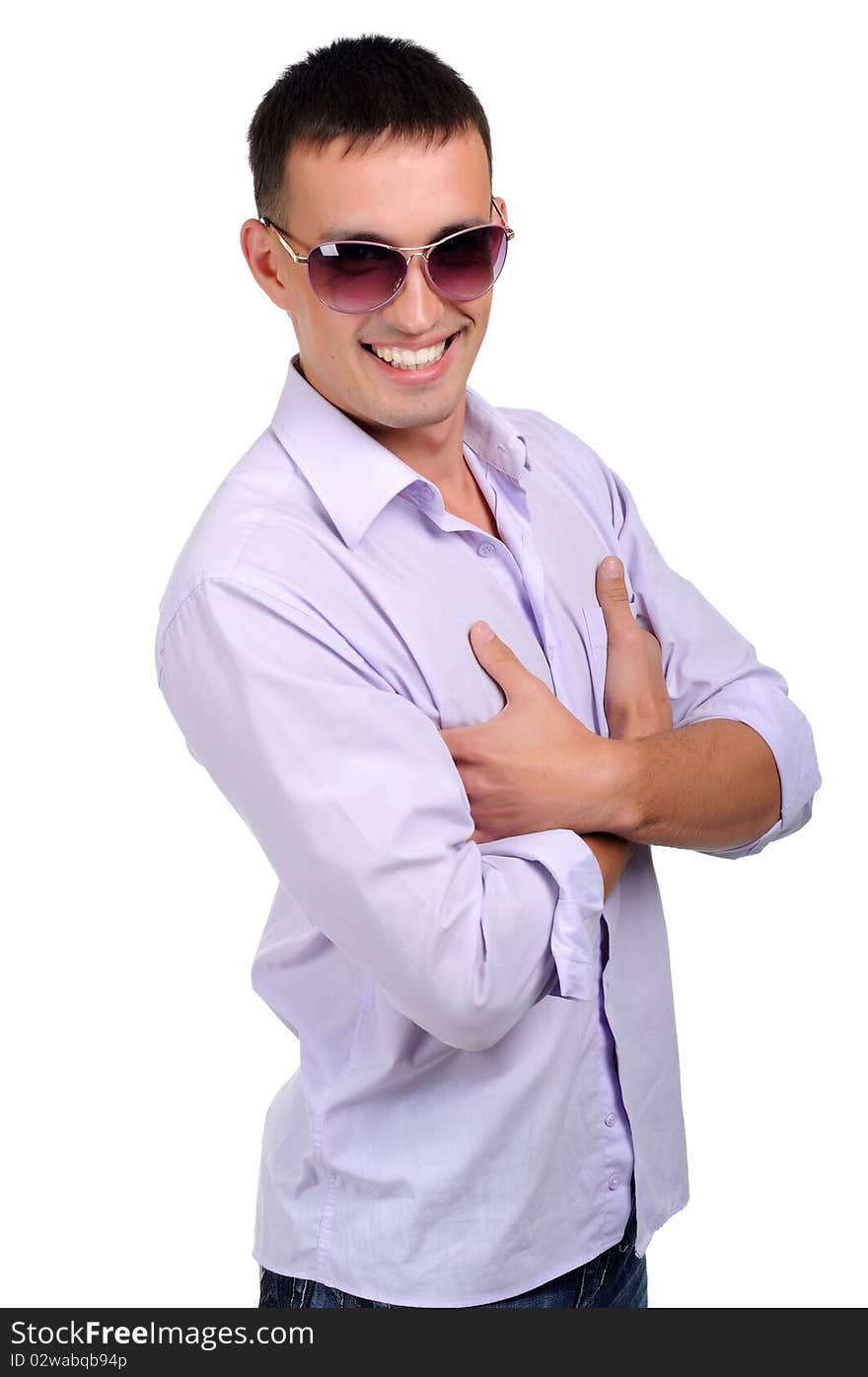 A young man in jeans and a light shirt and dark glasses