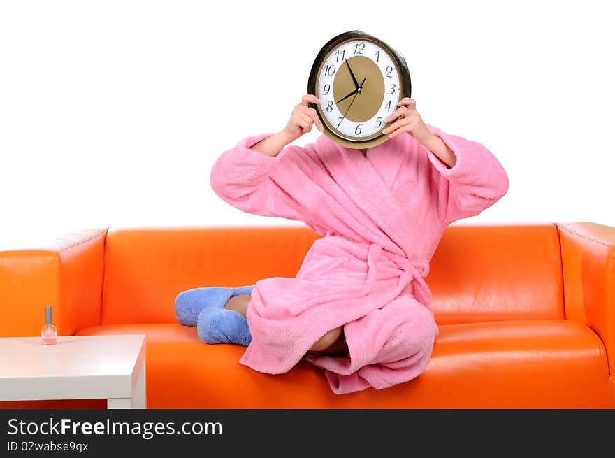 A funny girl in a pink gown with a watch in his hand