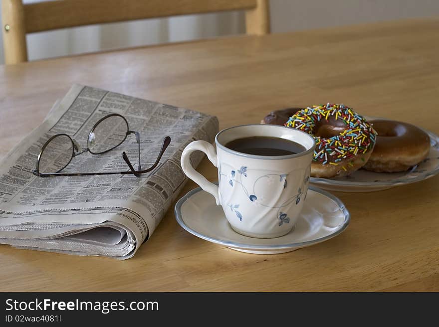 Coffee and donuts with the morning paper