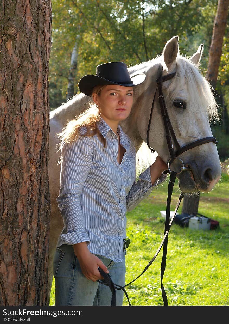 Girl-cowboy And White Horse