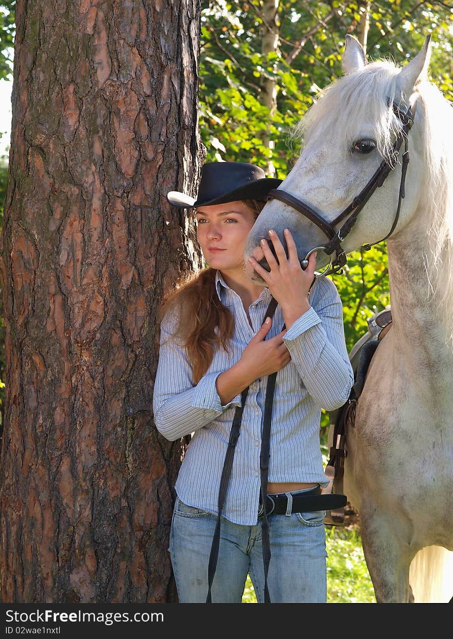 Girl-cowboy and white horse