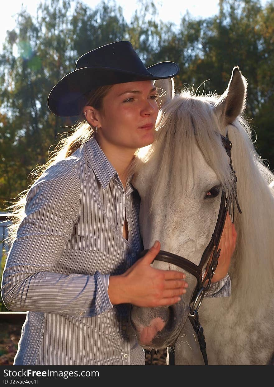 Girl-cowboy and white horse