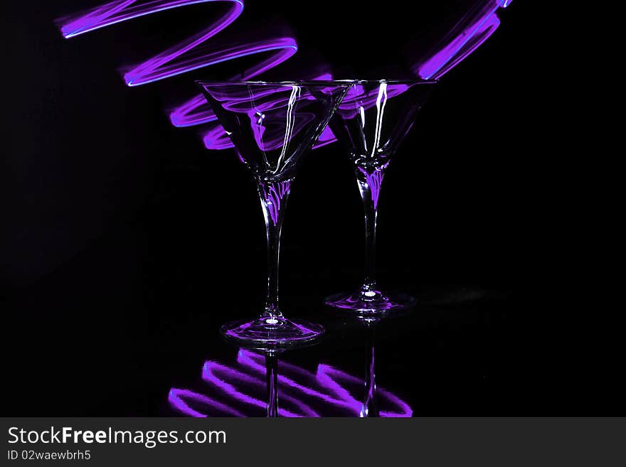 Pair martini glasses with purple light trails