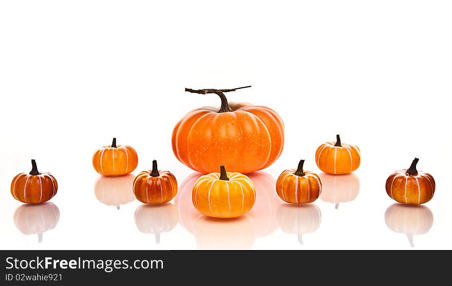 Large and small orange pumpkins centered on a white background. Large and small orange pumpkins centered on a white background.