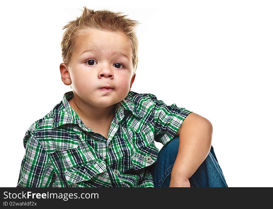 Adorable small boy looking at the viewer in a pensive mood. Adorable small boy looking at the viewer in a pensive mood.