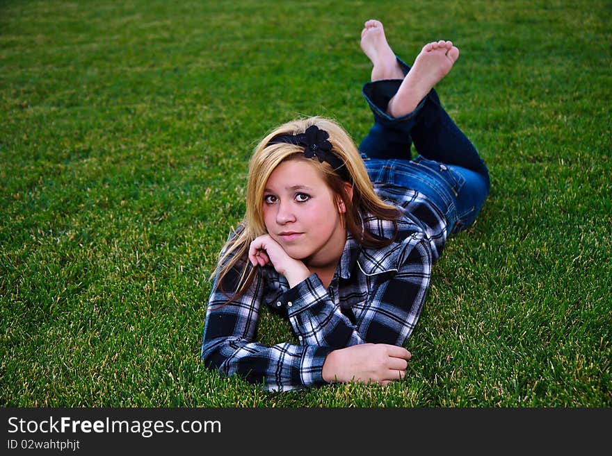 Cute teen enjoying the outdoors wearing plaid and a flower headband. Cute teen enjoying the outdoors wearing plaid and a flower headband.