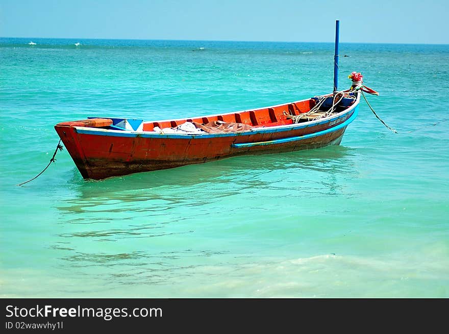 The wooden boat berthing in the offing