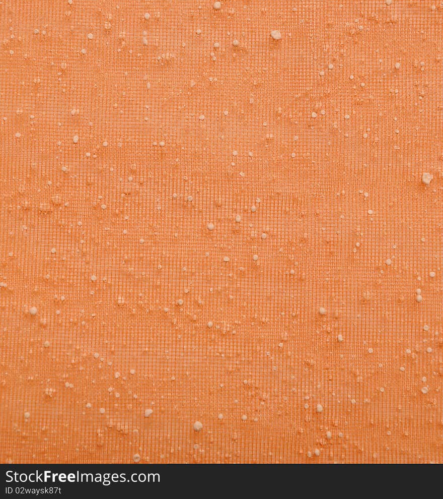 Close orange fine mesh with white dots. Close orange fine mesh with white dots