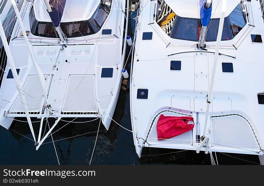 Two catamarans in a marina looking down on them