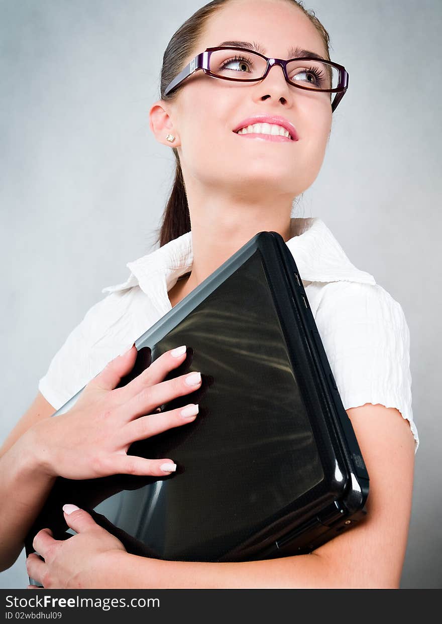 Young businesswoman with laptop and glasses may also be a student