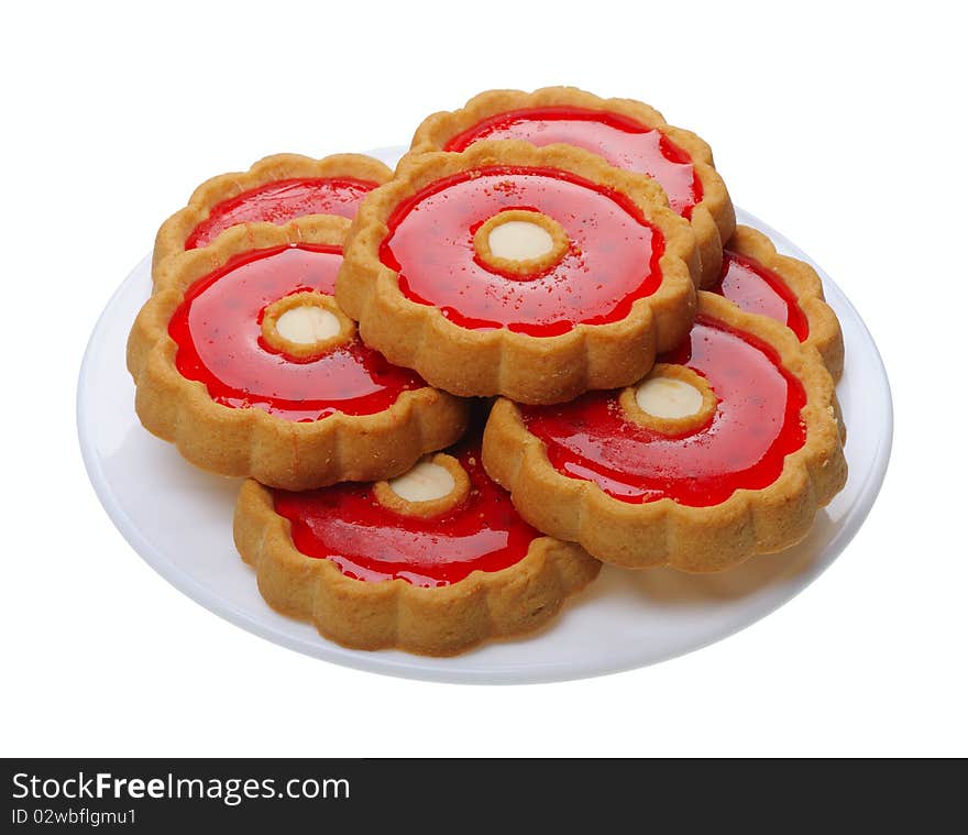 Cookies with red jelly on white plate, isolated