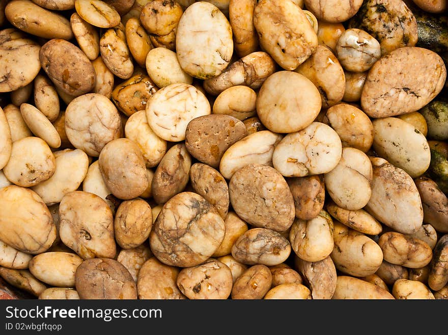 Natural Brown Pebbles beside of a waterfall