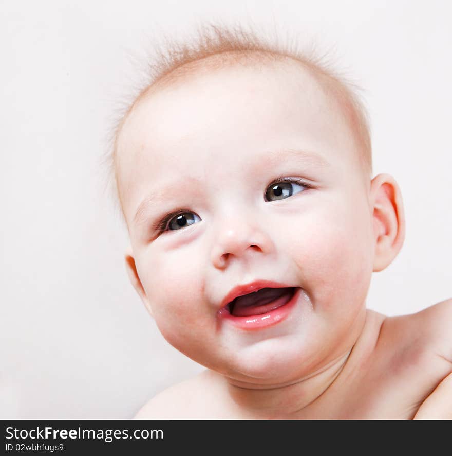 A joyful baby, closeup portrait