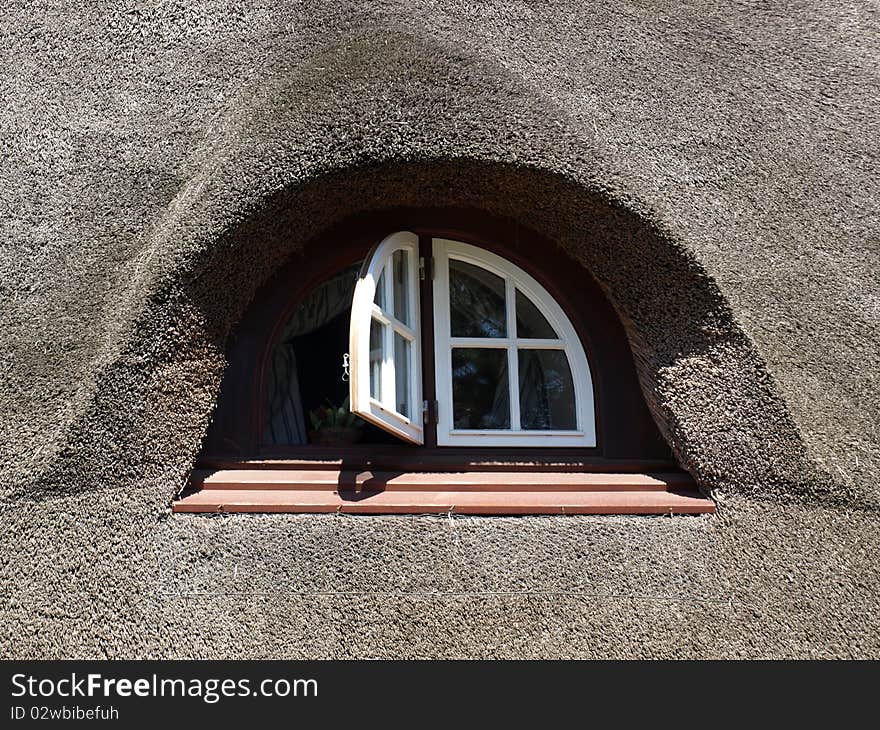 Nice window in a house with a reed roof