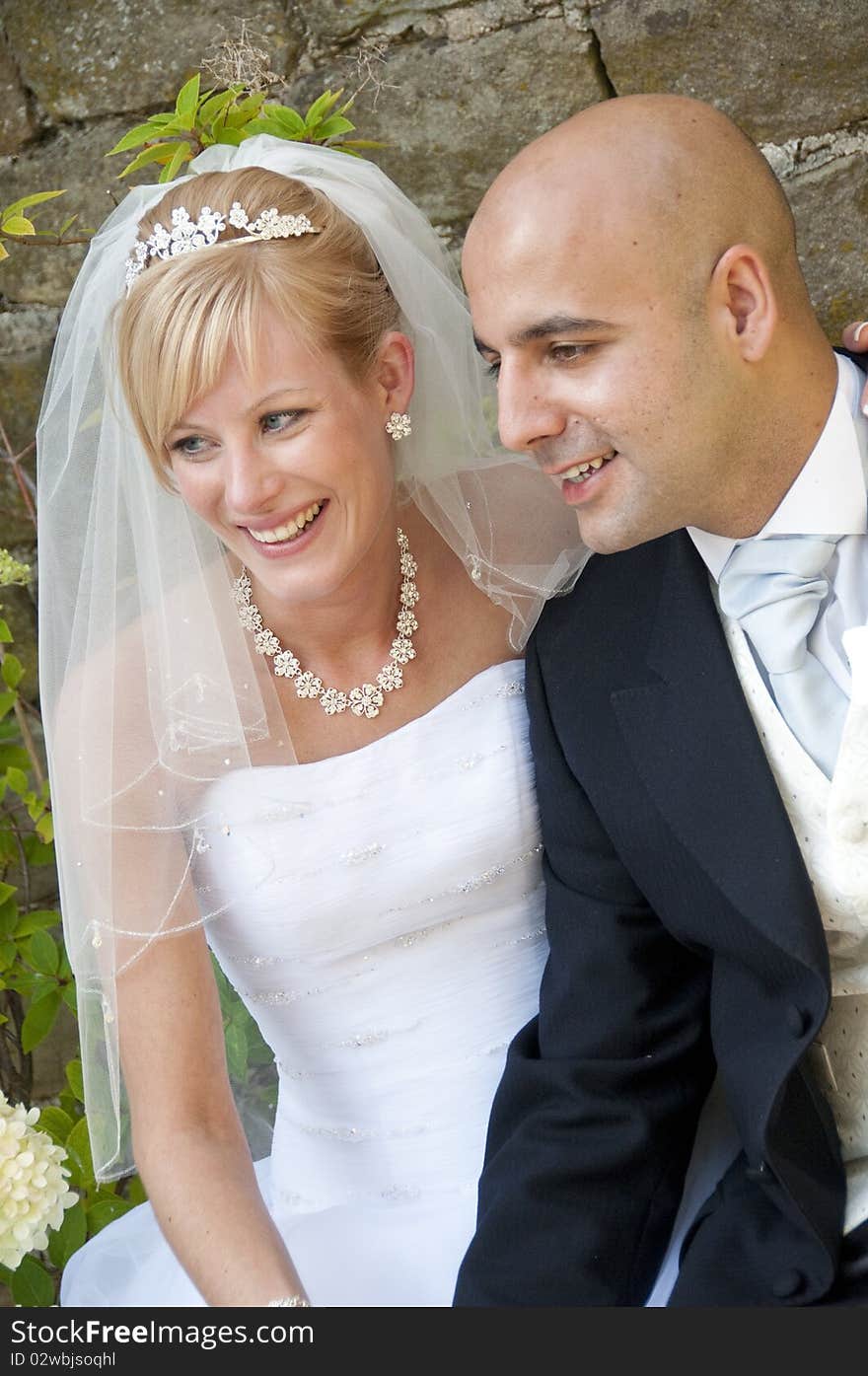 Happy bride and groom posing for their guests