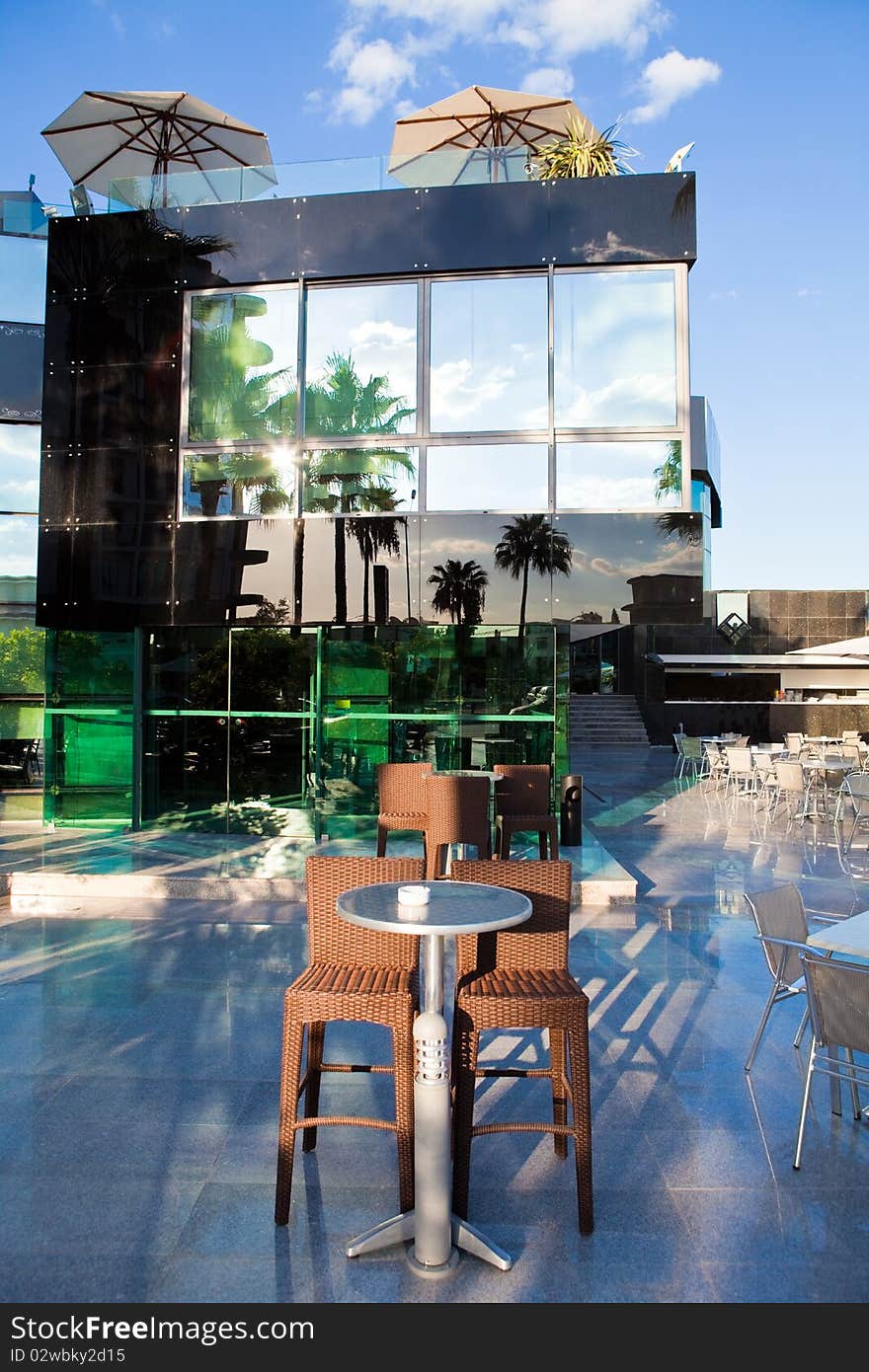 High wattled chairs and table in modern cafe