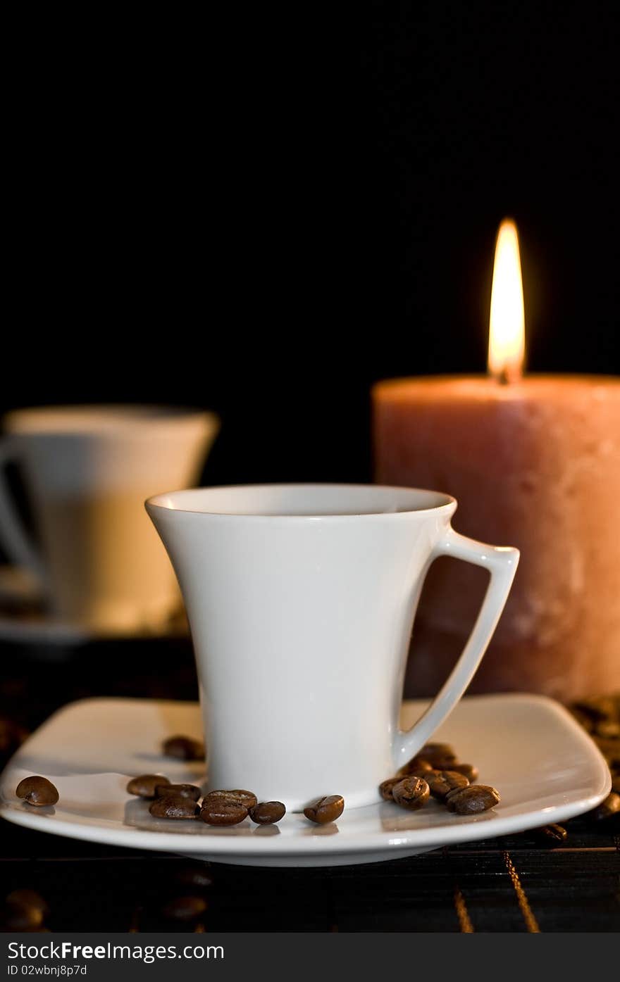 Candle and the cups of coffee.