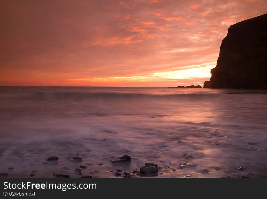 The setting sun lights up the beach at Crackington Haven, Cornwall as the tide goes out. The setting sun lights up the beach at Crackington Haven, Cornwall as the tide goes out.