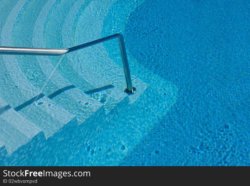 Steps and handrail into a swimming pool