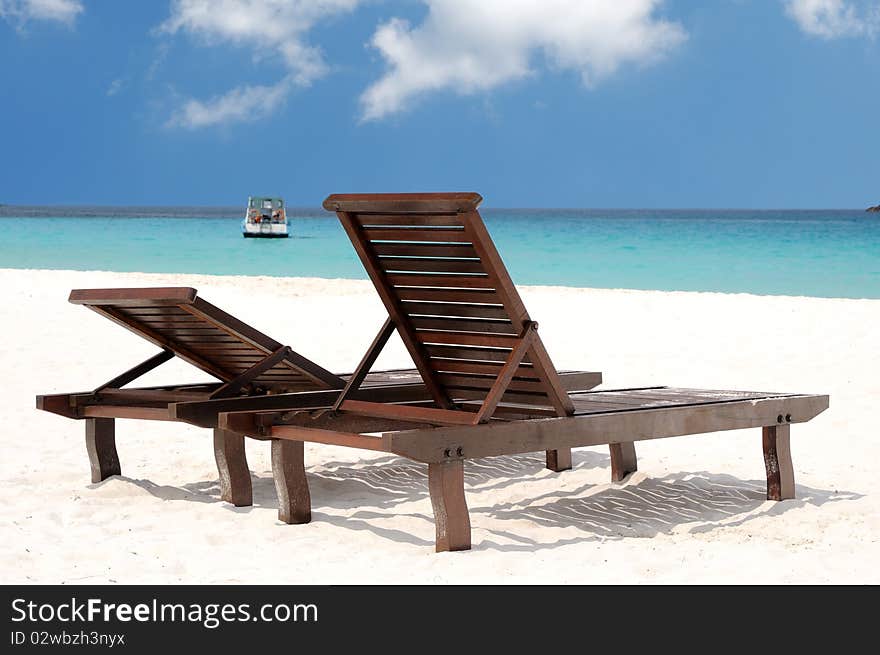 Two beach chairs on perfect tropical white sand