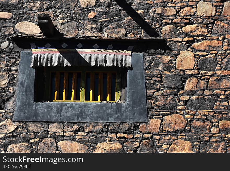 A window of typical Tibetan style in the rock wall at Lhasa,Tibet.Details. A window of typical Tibetan style in the rock wall at Lhasa,Tibet.Details.