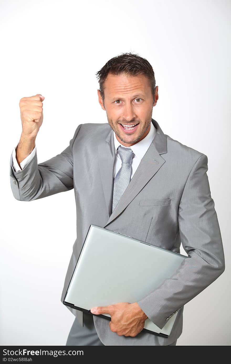 Businessman with laptop computer lifting arm up. Businessman with laptop computer lifting arm up