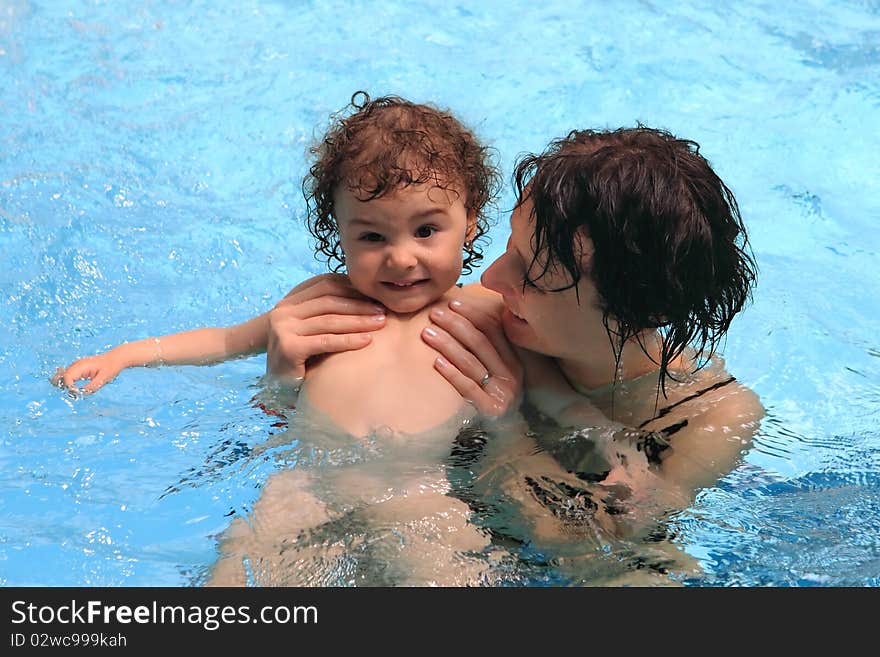 Mom learning baby how to swim. Mom learning baby how to swim