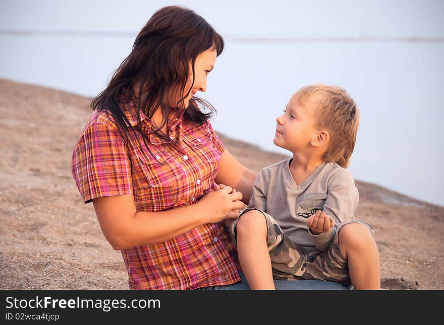 The mother and the son have a rest on seacoast