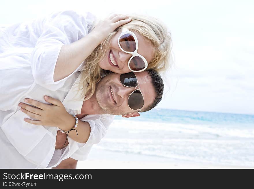 Portrait of young nice couple having good time on the beach. Portrait of young nice couple having good time on the beach