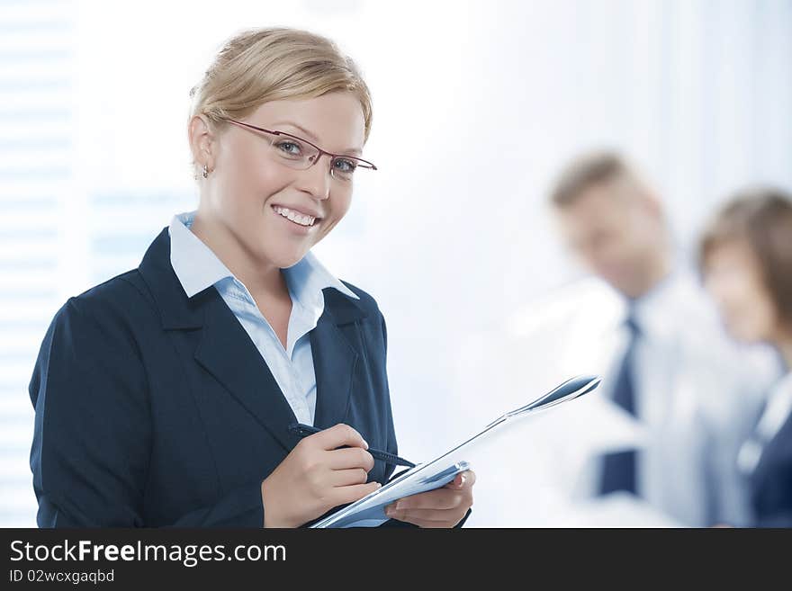 Portrait of young beautiful woman in office environment. Portrait of young beautiful woman in office environment