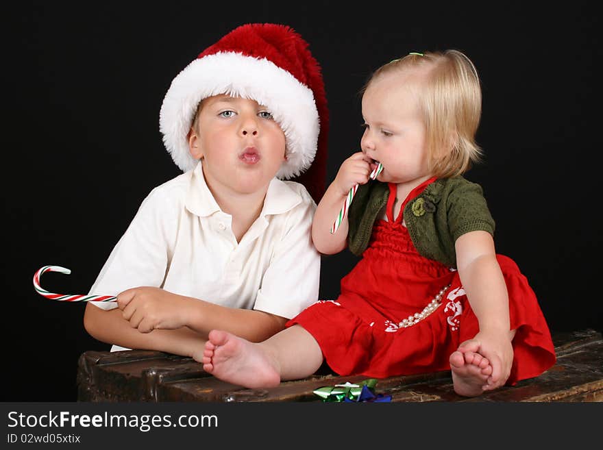 Christmas Brother and sister eating candy canes. Christmas Brother and sister eating candy canes