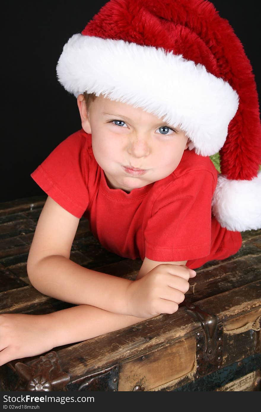 Cute boy with big blue eyes wearing a christmas hat. Cute boy with big blue eyes wearing a christmas hat