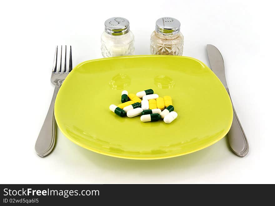 Pills as dinner on plate