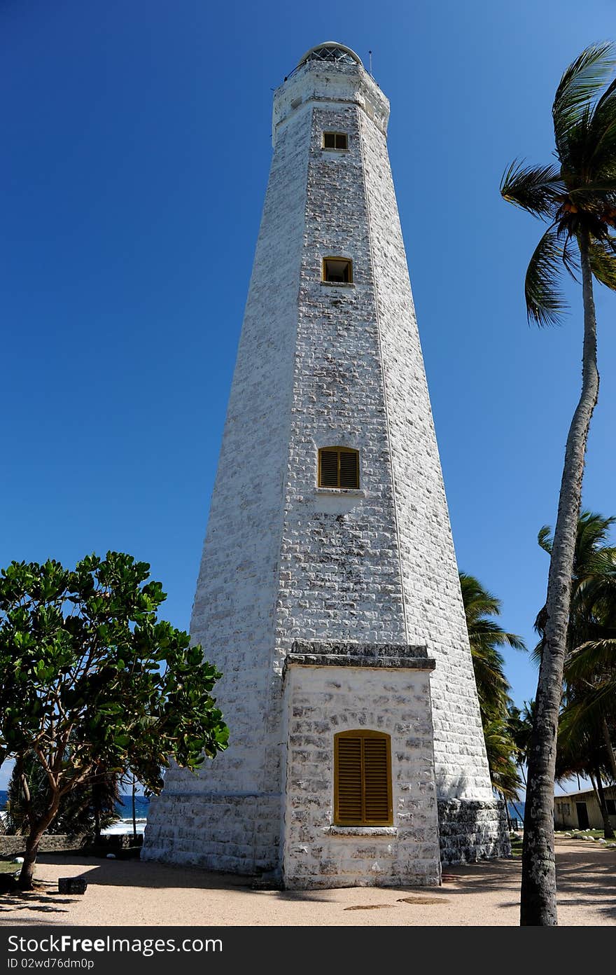 Lighthouse between palms galle sri lanka