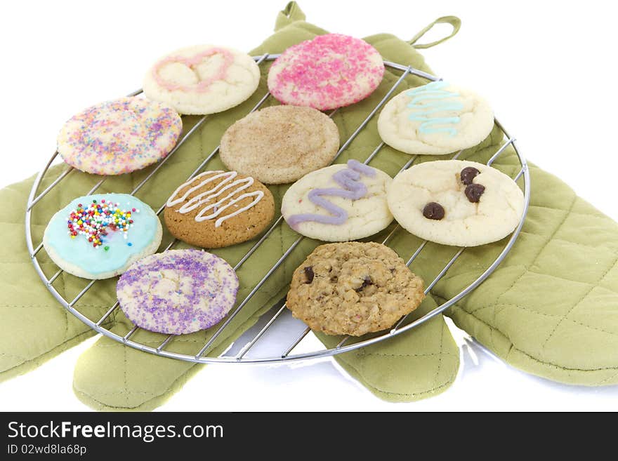 Homemade cookies on cooling rack with mitts