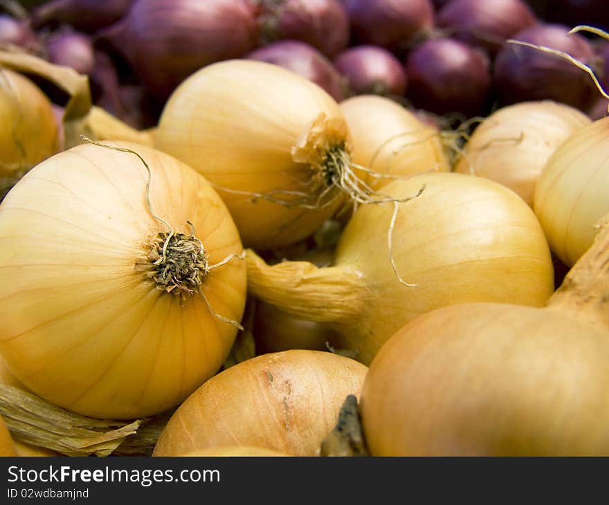 A pile of beautiful bulb onions on a counter. A pile of beautiful bulb onions on a counter