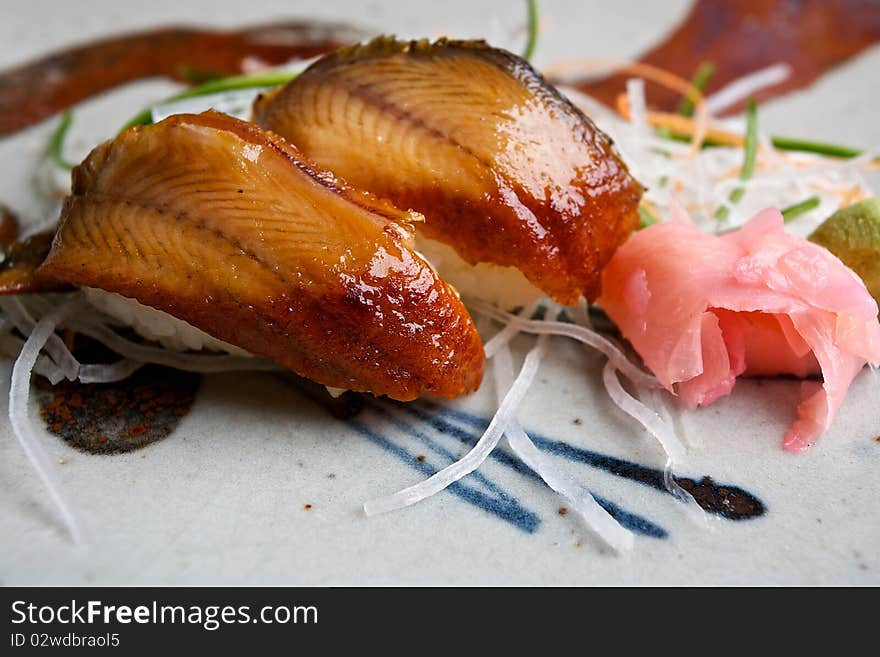 Japanese sushi cuisine served with ginger and rolled wasabi. Japanese sushi cuisine served with ginger and rolled wasabi.