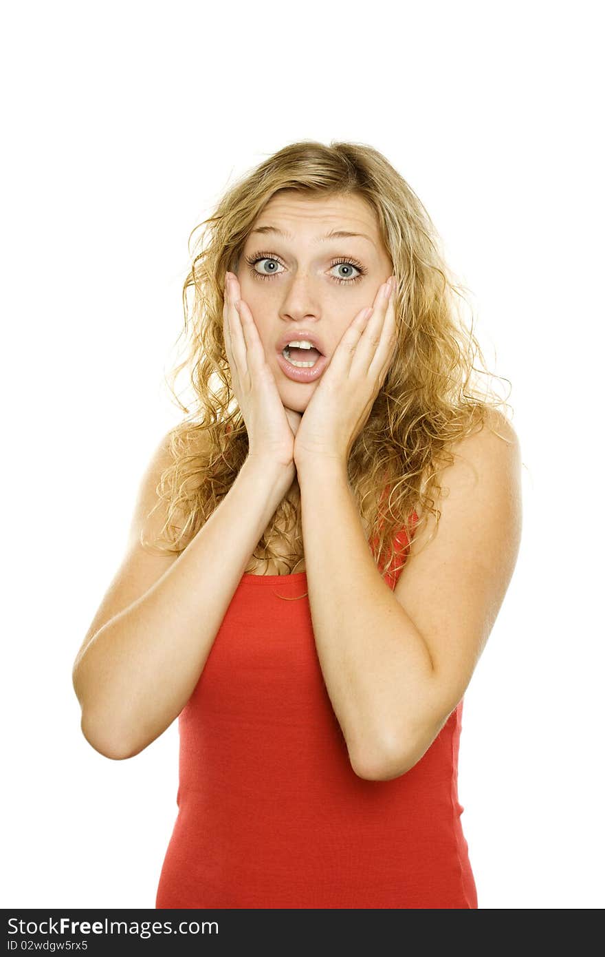 Young beautiful girl expresses emotions of shock. Isolated on a white background. Young beautiful girl expresses emotions of shock. Isolated on a white background