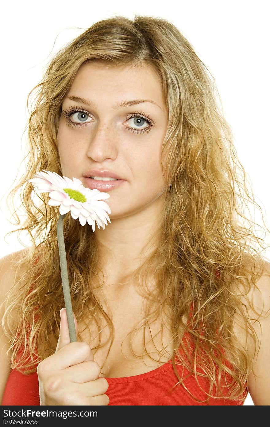 Closeup of the face a beautiful girl. Near face pink flower gerbera. Isolated on a white background. Closeup of the face a beautiful girl. Near face pink flower gerbera. Isolated on a white background.