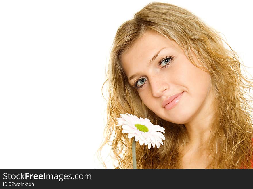 Closeup of the face a beautiful girl. Near face pink flower gerbera. Isolated on a white background. Closeup of the face a beautiful girl. Near face pink flower gerbera. Isolated on a white background