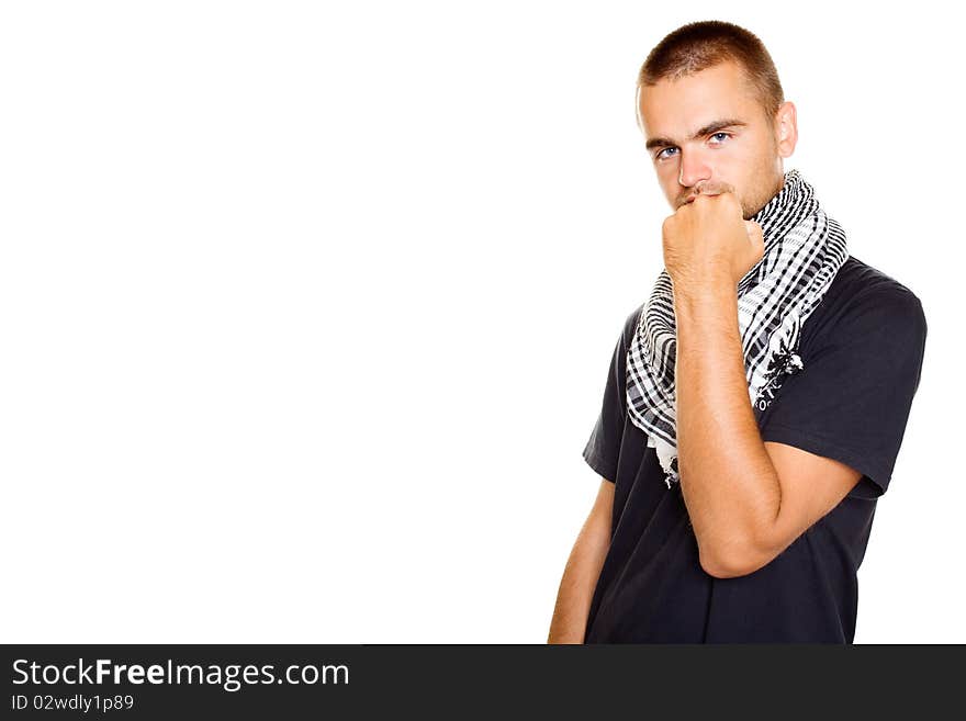 Young man dressed in black t-shirt at the neck of a Palestinian scarf. Stubble on his face. Shows a fist in the frame. Isolated on a white background. Young man dressed in black t-shirt at the neck of a Palestinian scarf. Stubble on his face. Shows a fist in the frame. Isolated on a white background