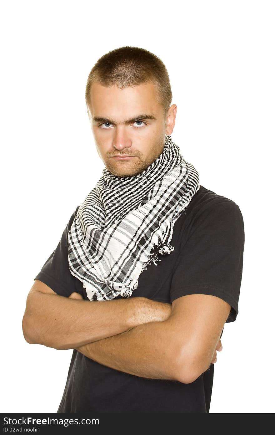 Young man dressed in black t-shirt on the face of a Palestinian scarf. Hands crossed on his chest. Stubble on his face. Isolated on a white. Young man dressed in black t-shirt on the face of a Palestinian scarf. Hands crossed on his chest. Stubble on his face. Isolated on a white