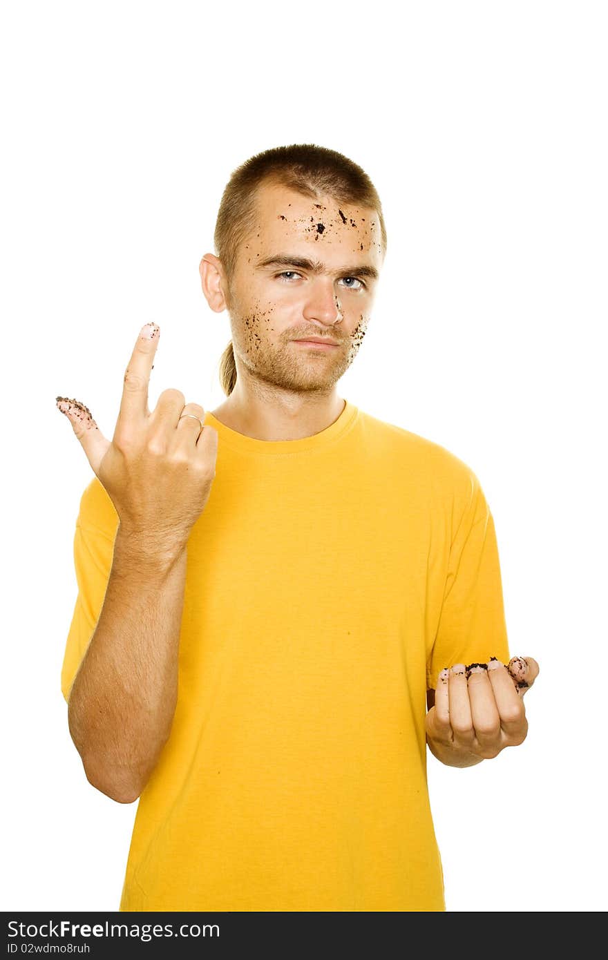 Handsome young man, his face and hands stained the soil. Finger of his right hand is raised. Isolated on a white background. Handsome young man, his face and hands stained the soil. Finger of his right hand is raised. Isolated on a white background