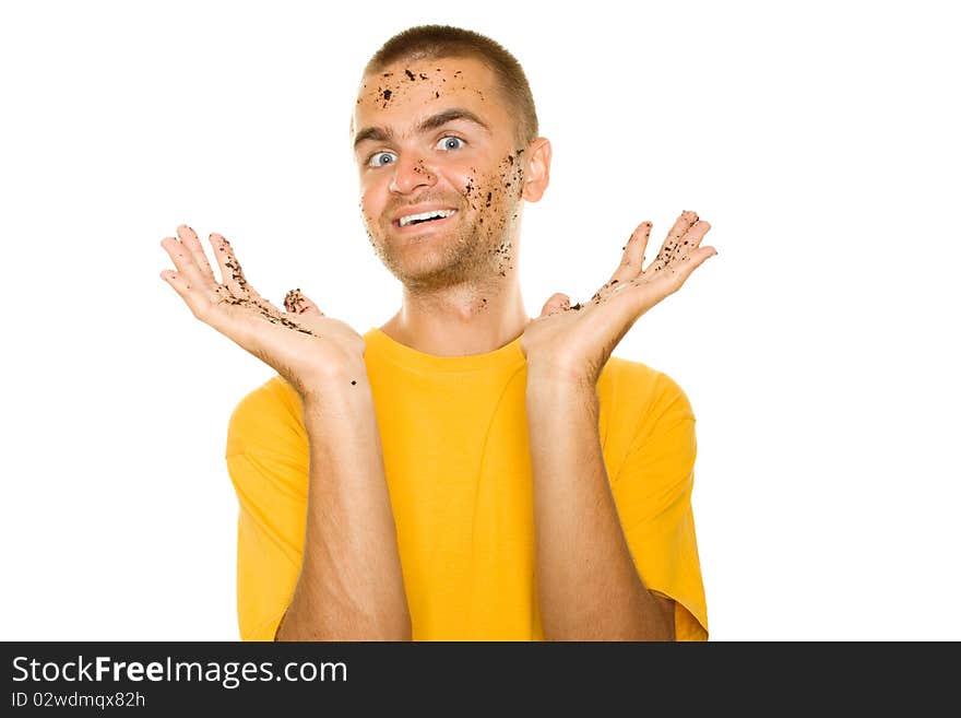 Handsome young man, his face and hands stained the ground. Guy pleased his hands raised up. Isolated on a white background. Handsome young man, his face and hands stained the ground. Guy pleased his hands raised up. Isolated on a white background