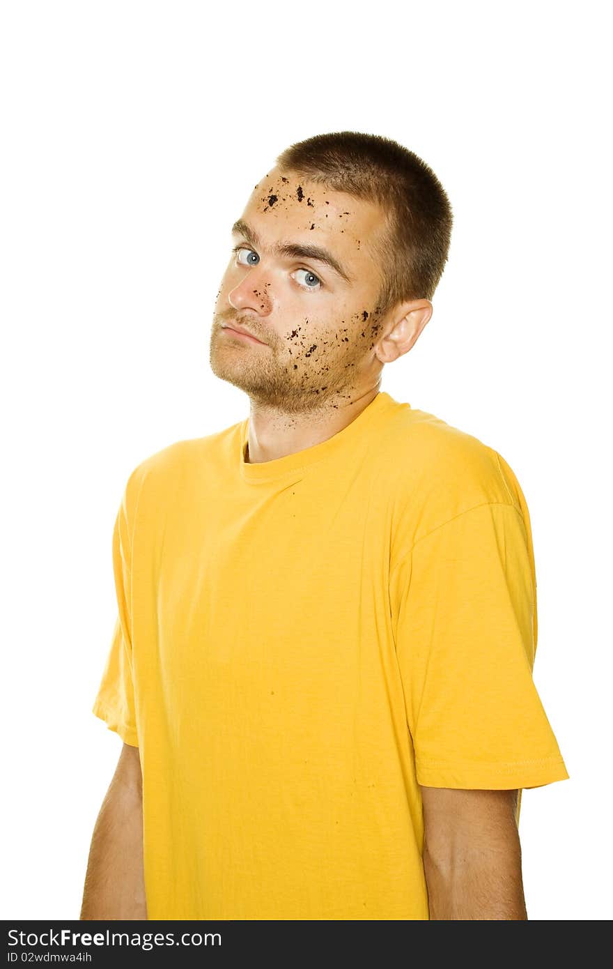 Handsome young man, his face and hands stained the ground. The guy shrugs. Isolated on a white background. Handsome young man, his face and hands stained the ground. The guy shrugs. Isolated on a white background