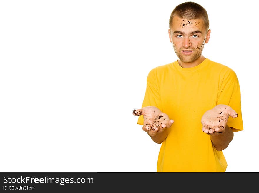 Handsome young man, his face and hands stained the ground. The guy pulls his hands to frame complaining. Isolated on a white background. Handsome young man, his face and hands stained the ground. The guy pulls his hands to frame complaining. Isolated on a white background