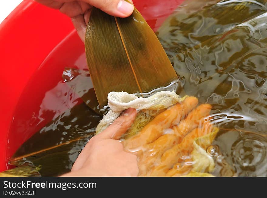 Preparing leaves for making Chinese dumplings. For food and beverage, and creative cuisine concepts. Preparing leaves for making Chinese dumplings. For food and beverage, and creative cuisine concepts.