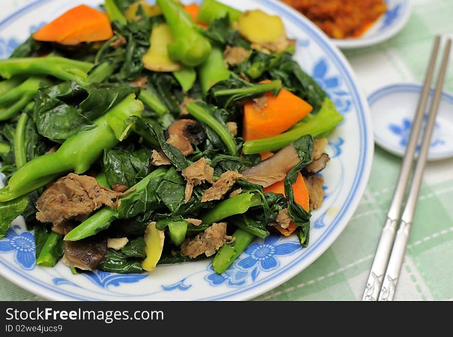 Asian style mixed vegetable delicacy cooked with leafy vegetables, mushrooms, carrots, and slices of ginger.